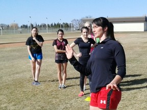 Babara Mervin from Rugby Canada leads a practice with teammate Brittany Waters for the Archbishop O'Leary girls rugby team at the school on April 9. (Aaron Taylor, QMI Agency)