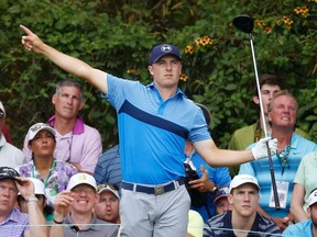 Jordan Spieth points to the direction his drive is heading off the 14th tee during the first round of the Masters at Augusta National Golf Course in Augusta, Ga., on Thursday, April 9, 2015. (Jim Young/Reuters)