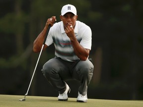 Tiger Woods looks over his putt on the 18th green during the first round of the Masters at Augusta National Golf Course in Augusta, Ga., on Thursday, April 9, 2015. (Phil Noble/Reuters)