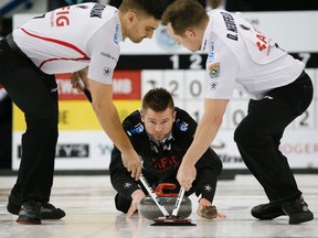 Mike McEwen follows through on his slide after releasing a rock during his team's win over Kevin Koe's team at the Players' Championship on April 9, 2015 in Toronto. (STAN BEHAL/Toronto Sun)