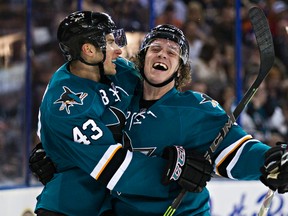 San Jose's Taylor Fedun, left, and Bryan Lerg celebrate lerg's game -winning goal against the Oilers during the third period Thursday at Rexall Palce. (Codie Mclachlan, Edmonton Sun)