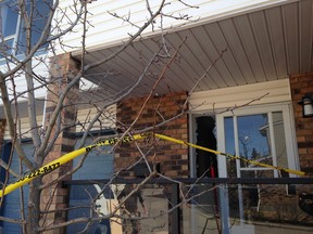 A teenage boy who lives in this condo at Coachway Garden S.W. narrowly avoided succumbing to carbon monoxide poisoning that had already knocked out his mother an sister. The teen passed out while on the phone with a 911 dispatcher early Friday, April 1,0, 2015. (Photo by Jim Well/Calgary Sun)