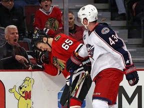 A fan yells as Andrew Shaw of the Chicago Blackhawks reacts after being hit by Scott Hartnell of the Columbus Blue Jackets during NHL play at the United Center March 27, 2015 in Chicago. (Jonathan Daniel/Getty Images/AFP)