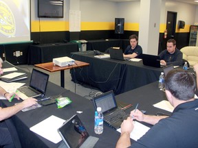 Counterclockwise from left, area scouts Jim Rauth, Dylan Seca and Kyle Higgins, and general manager Nick Sinclair prepare for the 2015 Ontario Hockey League Priority Selection in their war room at RBC Centre Friday. The Sting have 13 selections in total, including the 10th overall pick. (Terry Bridge, The Observer)