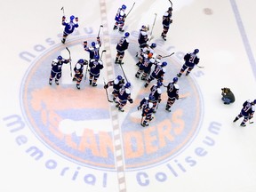 The New York Islanders celebrate their win over the Buffalo Sabres at the Nassau Veterans Memorial Coliseum on April 4, 2015 in Uniondale, N.Y. (Bruce Bennett/Getty Images/AFP)