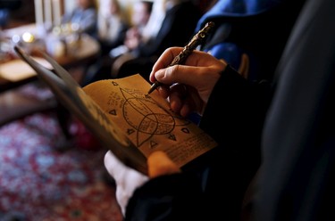 A participant draws on his 'secret book' during a workshop before the role play event at Czocha Castle in Sucha, west southern Poland April 9, 2015.Harry Potter enthusiasts from all over the world are attending a four-day live action role play event at the medieval castle made into a close imitation of the 'College of Wizardry'. REUTERS/Kacper Pempel