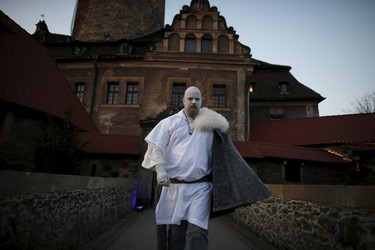 A participant walks in front of the castle before the role play event at Czocha Castle in Sucha, west southern Poland April 9, 2015. Harry Potter enthusiasts from all over the world are attending a four-day live action role play event at the medieval castle made into a close imitation of the 'College of Wizardry'. REUTERS/Kacper Pempel