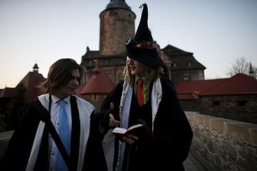 Participants chat as they walk in front of the castle before the role play event at Czocha Castle in Sucha, west southern Poland April 9, 2015. Harry Potter enthusiasts from all over the world are attending a four-day live action role play event at the medieval castle made into a close imitation of the 'College of Wizardry'. REUTERS/Kacper Pempel