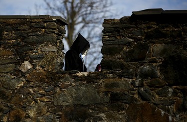 A participant walks near a castle defense wall before the role play event at Czocha Castle in Sucha, west southern Poland April 9, 2015.Harry Potter enthusiasts from all over the world are attending a four-day live action role play event at the medieval castle made into a close imitation of the 'College of Wizardry'. REUTERS/Kacper Pempel
