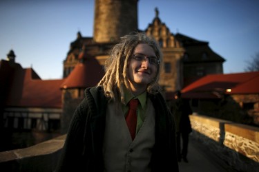 A participant smiles as he walks in front of the castle before the role play event at Czocha Castle in Sucha, west southern Poland April 9, 2015. Harry Potter enthusiasts from all over the world are attending a four-day live action role play event at the medieval castle made into a close imitation of the 'College of Wizardry'. REUTERS/Kacper Pempel