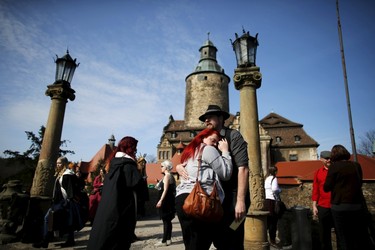 Participants hug each other as they arrived for the role play event at Czocha Castle in Sucha, west southern Poland April 9, 2015. Harry Potter enthusiasts from all over the world are attending a four-day live action role play event at the medieval castle made into a close imitation of the 'College of Wizardry'. REUTERS/Kacper Pempel
