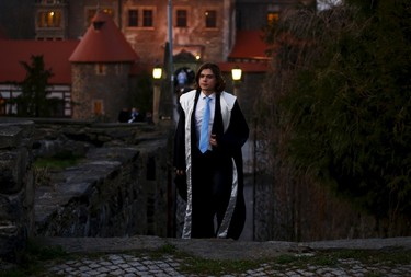 A participant walks in front of the castle before the role play event at Czocha Castle in Sucha, west southern Poland April 9, 2015. Harry Potter enthusiasts from all over the world are attending a four-day live action role play event at the medieval castle made into a close imitation of the 'College of Wizardry'. REUTERS/Kacper Pempel