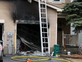Kingston Fire and Rescue respond to a garage fire on Littlestone Crescent in Kingston, Ont. on Friday April 10, 2015. No one was in the home at the time, and no injuries were reported. Steph Crosier/Kingston Whig-Standard/QMI Agency