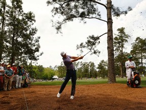 Jordan Spieth of the U.S. hits from the rough on the 14th fairway during second round play of the Masters golf tournament at the Augusta National Golf Course on April 10, 2015. (REUTERS/Mark Blinch)