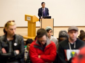 Western University president Amit Chakma talks about the controversy surrounding his $1 million paycheque as several protesters stand with their backs turned in protest to the embattled university leader at a school senate meeting at the Ivey School of Business in London, Ontario on Friday April 10, 2015. (CRAIG GLOVER, The London Free Press)