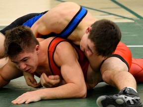 Nick Wendt (on top in the blue) pins down an opponent en route to his third-place finish at the zone championships last month. - Mitch Goldenberg, Reporter/Examiner