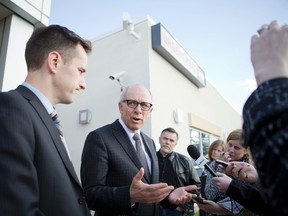 Airdrie, Alta. - Health Minister Stephen Mandel (middle) talks to reporters with MLA Rob Anderson at the Airdrie Regional Community Health Centre after Mandel announced there will be a 24-hour health facility in the city's future on Monday, March 30, 2015. BRITTON LEDINGHAM / AIRDRIE ECHO