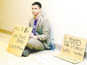 Western PhD student Tyler Turek was looking to raise the equivalent of Western president Amit Chakma?s extra year?s pay for the University Students? Council food bank. Turek set up just outside the office of the president in the Stevenson-Lawson building at Western University on April 1. Turek was quitting his studies due to the cost while the president received nearly a million dollars last year. (London Free Press file photo)