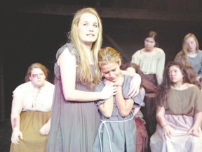 Andromache, played by Marissa Rasmussen, holds onto her son Astyanax, played by Evelyn Moie-Bazely, before the child is taken away and killed during a scene from the Original Kids Theatre Company production of The Trojan Women at the Spriet Family Theatre in the Covent Garden Market. (CRAIG GLOVER, The London Free Press)