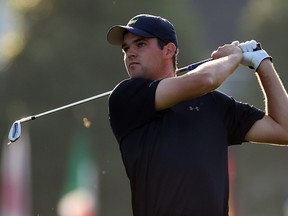 Corey Conners of Canada watches his shot from the 1st hole fairway during Round 1 of the 79th Masters Golf Tournament at Augusta National Golf Club on April 9, 2015. (AFP PHOTO/DON EMMERT)