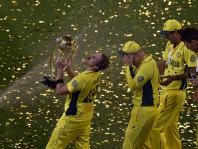 Australian David Warner (left) sprays champagne in celebration of their Cricket World Cup title victory in Melbourne  last month. Warner joins Sunrisers Hyderabad in IPL play on Saturday. (AFP/PHOTO)