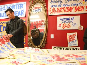 Shoppers sift through the signs for sale at Honest Ed's on April 11, 2015. (Veronica Henri/Toronto Sun)