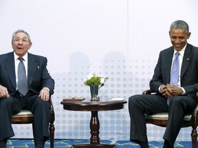 U.S. President Barack Obama smiles during a meeting with Cuba's President Raul Castro, who listens to a translator, during the first plenary session of the Summit of the Americas in Panama City, Panama April 11, 2015. Obama and Castro shook hands on Friday at the summit, a symbolically charged gesture as the pair seek to restore ties between the Cold War foes. REUTERS/Jonathan Ernst