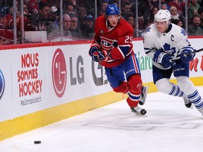 acob De La Rose #25 of the Montreal Canadiens and Dion Phaneuf #3 of the Toronto Maple Leafs chase the puck into the corner during the NHL game at the Bell Centre on January 17, 2015 in Montreal, Quebec, Canada.  Richard Wolowicz/Getty Images/AFP