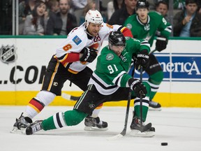 Dallas Stars center Tyler Seguin (91) passes the puck as Calgary Flames defenseman Dennis Wideman (6) defends during the third period at the American Airlines Center. Seguin scores a goal in the first. The Flames defeated the Stars 5-3.  Jerome Miron-USA TODAY Sports