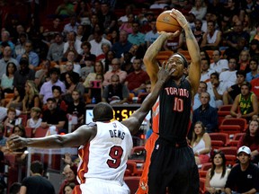 Raptors guard DeMar DeRozan shoots over Heat forward Luol Deng during the first half at American Airlines Arena in Miami last night. (USA TODAY)