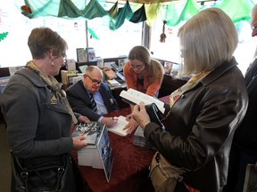 Edmonton Sun writer Cam Tait signs a copy of his book at Audrey's Books in Edmonton, Alta., on April 11, 2015, 2015. Perry Mah/Edmonton Sun/