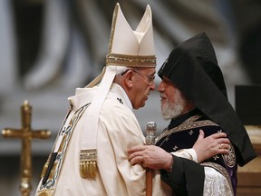 Pope Francis (L) embraces Catholicos of All Armenians Karekin II during a mass on the 100th anniversary of the Armenian mass killings, in St. Peter's Basilica at the Vatican April 12, 2015. REUTERS/Tony Gentile