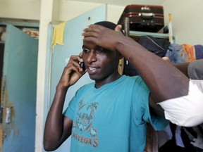 Harun Njoroge a student at the University of Nairobi speaks on his cell-phone inside his room after receiving treatment after he  jumped from the window at the Kimberly hostels at the Kikuyu campus near the capital Nairobi, April 12, 2015. REUTERS/Thomas Mukoya