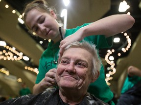 Mary Gray receives a haircut from MC College's Nala Cooper during Homeward Trust Edmonton's Homeless Connect event at the Shaw Conference Centre in Edmonton, Alta., on Sunday, Oct. 19, 2014. Community groups and agencies band together under one roof twice per year to assist those battling homelessness in the Capital City. Ian Kucerak/Edmonton Sun/ QMI Agency