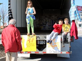 Genevieve de Wys, 9, explains to Frank Normand the TP the Town program, while fellow volunteers, Kilian Le Coze-Oliveros,9, in red shirt, and Benjamin Winterborn, 9, wait for more toilet paper donations on Saturday. Steph Crosier, The Whig-Standard, QMI Agency