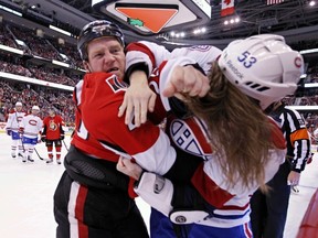 Ottawa Senators' Chris Neil fights with Montreal Canadiens' Ryan White during NHL hockey action at the Canadian Tire Centre in Ottawa on Wednesday September 25,2013. Errol McGihon/The Ottawa Sun/QMI Agency