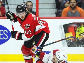 Ottawa Senators' Erik Karlsson knocks down Montreal Canadiens' Max Pacioretty during NHL hockey action at the Canadian Tire Centre in Ottawa, Ontario on Friday October 3, 2014. Errol McGihon/Ottawa Sun/QMI Agency