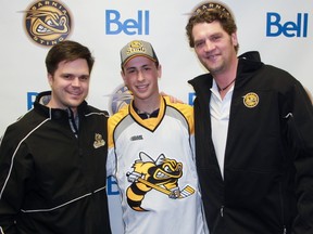 Sarnia Sting general manager Nick Sinclair, left, and head coach Derian Hatcher pose with first-round draft pick Sasha Chmelevski. The Sting selected Chmelevski, a centre from Detroit Honeybaked, with the 10th overall pick of Saturday's OHL Priority Selection. Terry Bridge/Sarnia Observer/QMI Agency