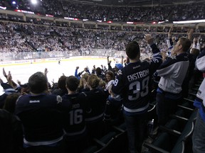 Winnipeg Jets fans celebrate in the waning seconds of a 5-1 win over the Calgary Flames during NHL action at MTS Centre in Winnipeg, Man., on Sat., April 11, 2015. (Kevin King/Winnipeg Sun/QMI Agency)