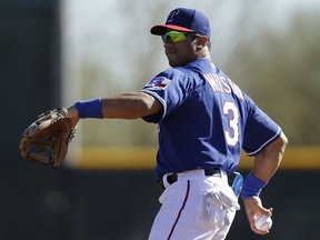 Russell Wilson of the Texas Rangers throws in the outfield during a work out before the game against the Cleveland Indians at Surprise Stadium on March 03, 2014. (Mike McGinnis/Getty Images/AFP)