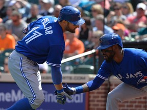 Toronto Blue Jays center fielder Kevin Pillar celebrates with  shortstop Jose Reyes after hitting a solo home run during the second inning against the Baltimore Orioles at Oriole Park at Camden Yards on April 12, 2015. (Tommy Gilligan/USA TODAY Sports)