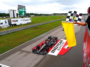 Canadian James Hinchcliffe drives under the checkered flag to win the  Grand Prix of Louisiana at NOLA Motorsports Park yesterday.