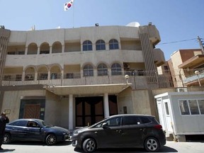 A man walks past the South Korean embassy after it was attacked by gunmen in Tripoli April 12, 2015.   REUTERS/Ismail Zitouny