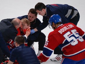 Medical staff attend to Montreal Canadiens' Lars Eller who was injured in the face during the second period NHL action against the Ottawa Senators on  Thursday May 2, 2013 in Montreal. Martin Chevalier/Journal de Montreal/QMI Agency