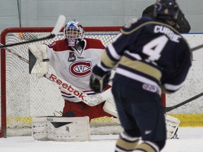 Kingston Voyageurs goalie Daniel Urbani blocks a shot by Toronto Patriots' Tyler Currie during Game 2 of the Ontario Junior Hockey League Buckland Cup at the Invista Centre on Sunday. (Ian MacAlpine/The Whig-Standard)