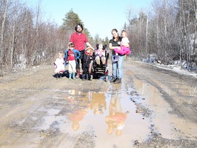 Danielle and Jonathan Tweed with their children Orion, Jude, Naima and Tovah, along with Ashelee who resides with the family, at the repaired washout on Penny Lane off Highway 537 on Sunday April 12, 2015. Gino Donato/Sudbury Star