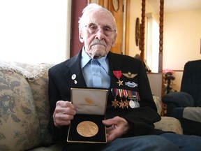 Harry Wilks, who fought in the Devil's Brigade in the Second World War, holds the congressional gold medal he received. Gino Donato/Sudbury Star