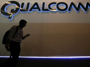 A man walks past Qualcomm stand while attending the Mobile World Congress in Barcelona March 3, 2015.    REUTERS/Albert Gea