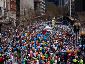 Runners make their way down Boylston Street after finishing the Boston Marathon in Boston, Massachusetts, April 21, 2014. REUTERS/Gretchen Ertl