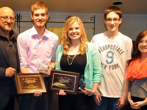 Mitchell Minor Sports president Mark Moore (left) presented Jake Donnelly and Danielle Patton with their 2014 male and female athlete of the year award in April 2014. On hand were members of the Sawyer family, Adam Sawyer and Lisa Van Moorsel. ANDY BADER FILE PHOTO